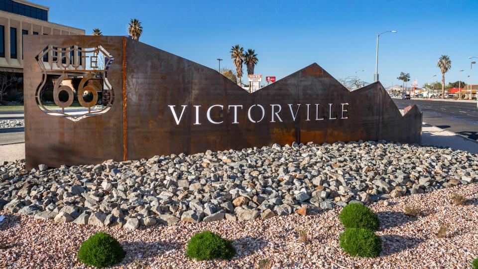 Victorville, CA / USA â€“ March 30, 2019:  Located on the corner of 7th St and Green Tree Blvd in the city of Victorville stands a rustic metal artwork featuring the Route 66 logo and the city name.