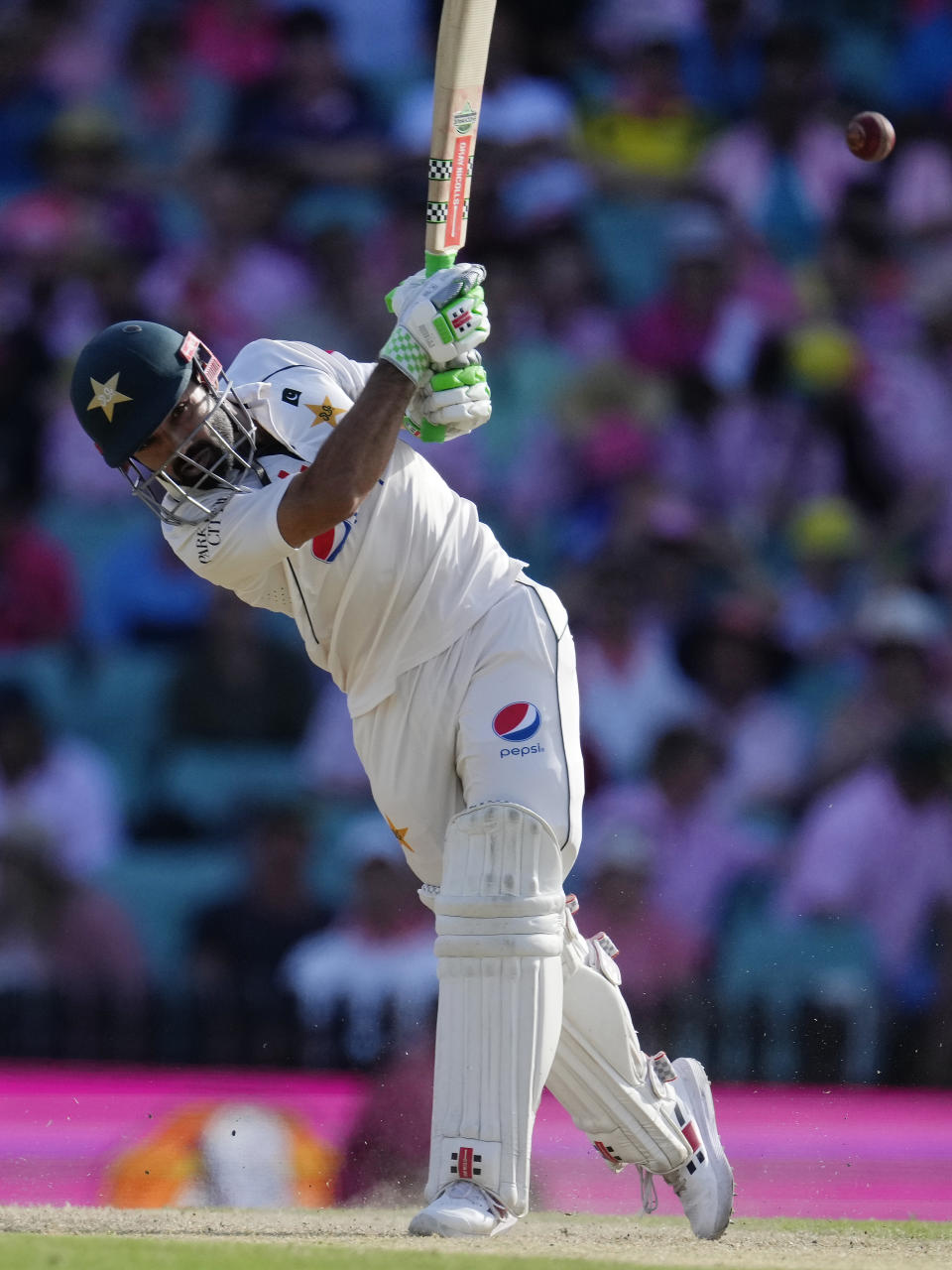 Pakistan's Mohammad Rizwan drives a delivery very from Australia's Travis Head on the third day of their cricket test match in Sydney, Friday, Jan. 5, 2024. (AP Photo/Rick Rycroft)