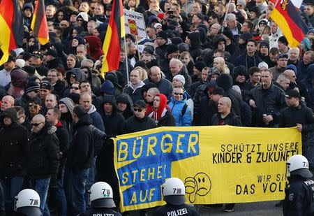 Supporters of anti-immigration right-wing movement PEGIDA (Patriotic Europeans Against the Islamisation of the West) take part in in demonstration march, in reaction to mass assaults on women on New Year's Eve, in Cologne, Germany, January 9, 2016. Banner reads : ' Citizens stand up. Protect our children and future. We are the people' REUTERS/Wolfgang Rattay