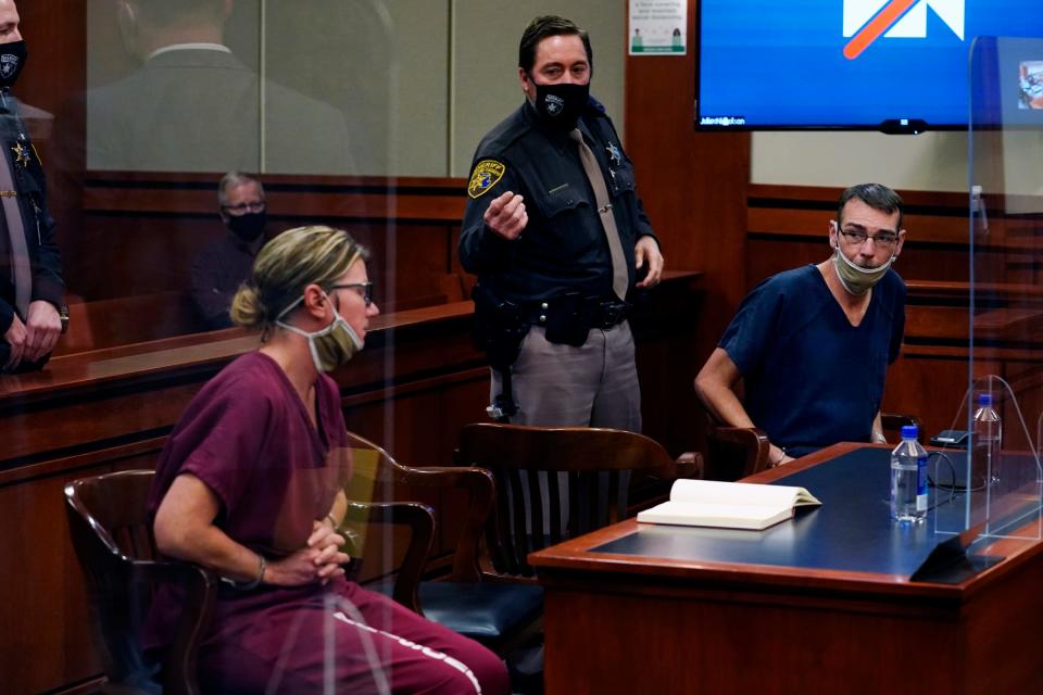 An Oakland County sheriff's deputy instructs Jennifer Crumbley to put her mask back up. The parents of accused Oxford High School gunman Ethan Crumbley, Jennifer and James Crumbley are in the 52-3 District Courtroom of Judge Julie Nicholson in Rochester on Dec. 14, 2021.