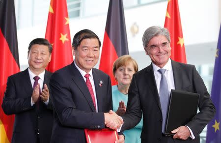 Siemens President and CEO Joe Kaeser shakes hands with He Lifeng, Director of National Development and Reform Commission (NDRC) agency, during a contract signing ceremony at the Chancellery in Berlin, Germany, July 5, 2017. REUTERS/Axel Schmidt