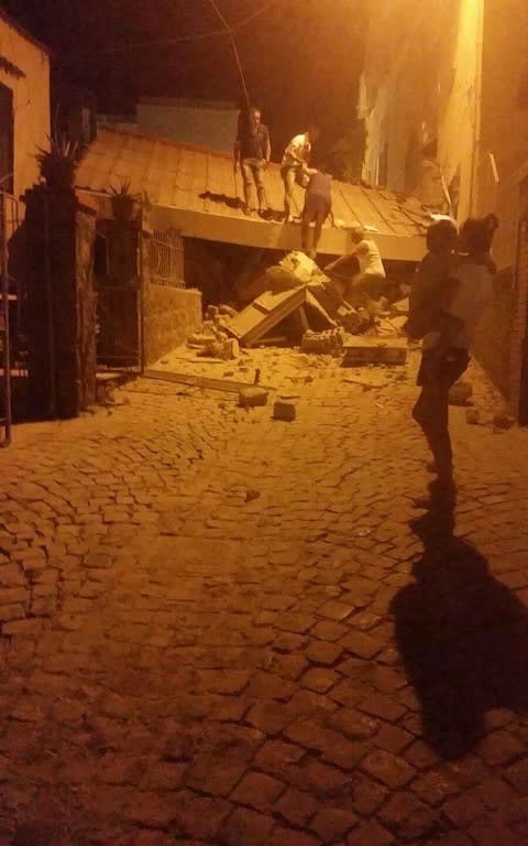 People remove debris after an earthquake hit Ischia island, near Naples, Southern Italy, Monday, Aug. 21, 2017 - Credit: ANSA