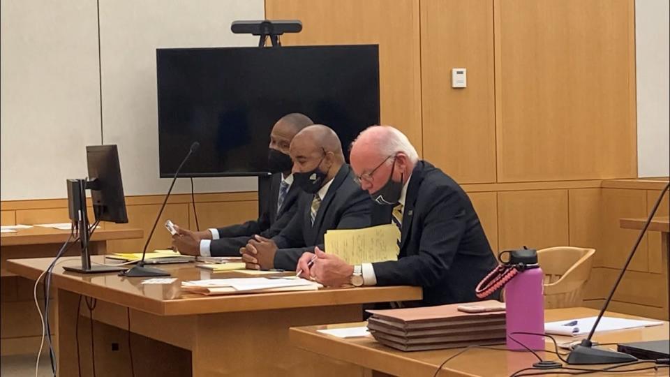 Martin Bailey, in the middle, is surrounded by his lawyers, Mayo Bartlett on the left and Bruce Bendish on the right, during his trial in Westchester County Court on June 13, 2022.