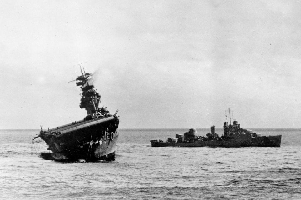 FILE - In this photo provided by the U.S. Navy, the USS Yorktown lists heavily to port after being struck by Japanese bombers and torpedo planes in the Battle of Midway on June 4, 1942. Footage from remote submersibles taken three miles under the Pacific Ocean is giving the world the first detailed glimpse of three World War II aircraft carriers that sunk in the pivotal Battle of Midway, which marked a shift in control of the Pacific naval theater from Japanese to U.S. forces. (U.S. Navy via AP, File)