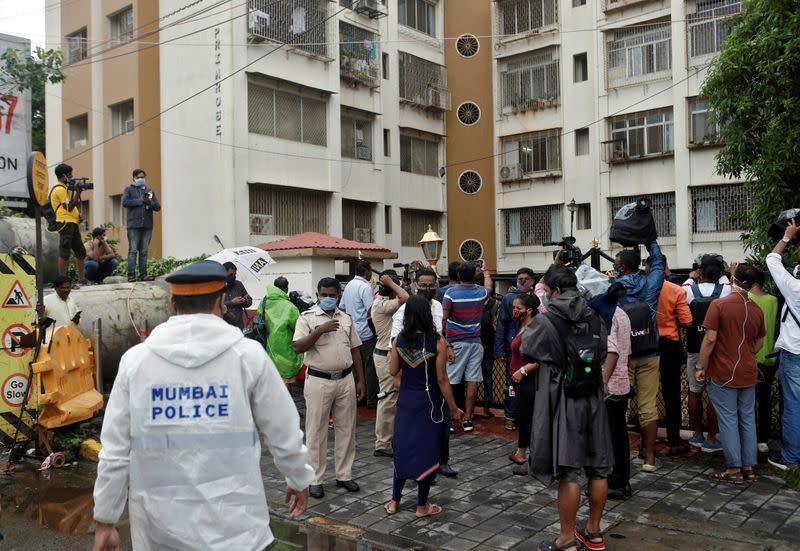 Police officers arrive to clear media personnel from the gate of the residence of Bollywood actor Rhea Chakraborty before she leaves her home for CBI office for questioning, in Mumbai