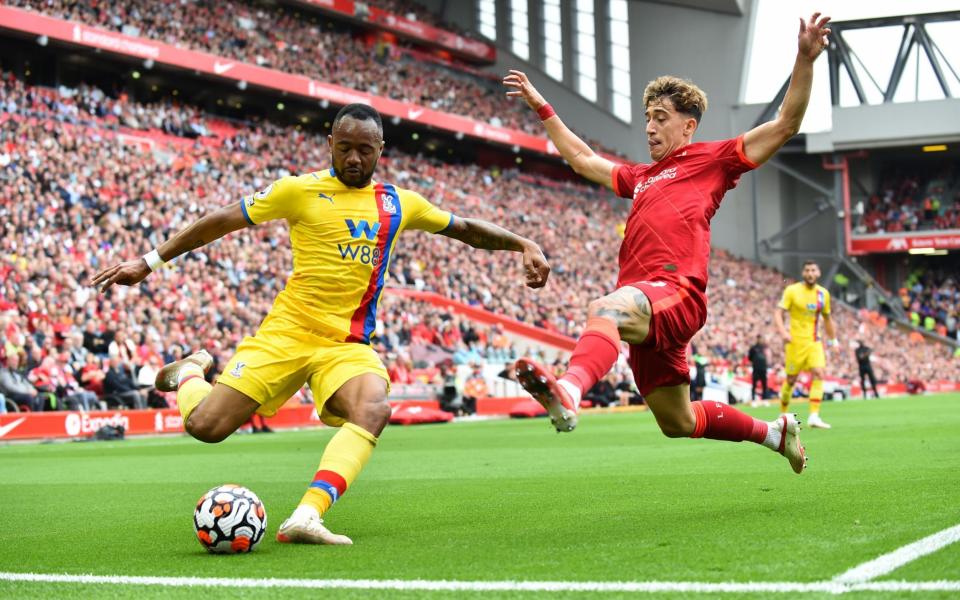 Crystal Palace's Jordan Ayew in action with Liverpool's Kostas Tsimikas - Reuters
