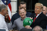 President Donald Trump prepares to return a signed hardhat after signing a new North American trade agreement with Canada and Mexico, during an event at the White House, Wednesday, Jan. 29, 2020, in Washington. (AP Photo/Alex Brandon)