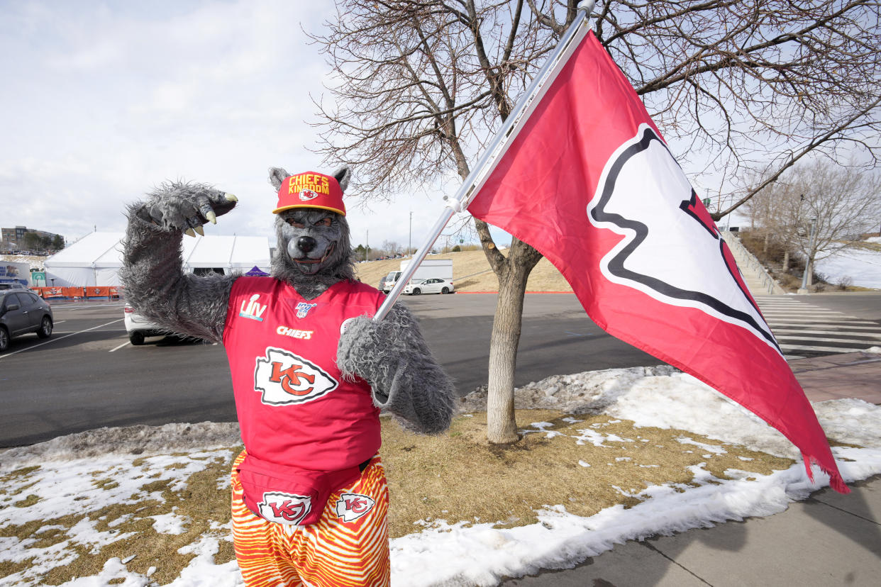 A Kansas City Chiefs fan, Chiefsaholic, poses for photos while walking toward Empower Field at Mile High before an NFL football game between the Denver Broncos and the Chiefs Saturday, Jan. 8, 2022, in Denver. (AP Photo/David Zalubowski)