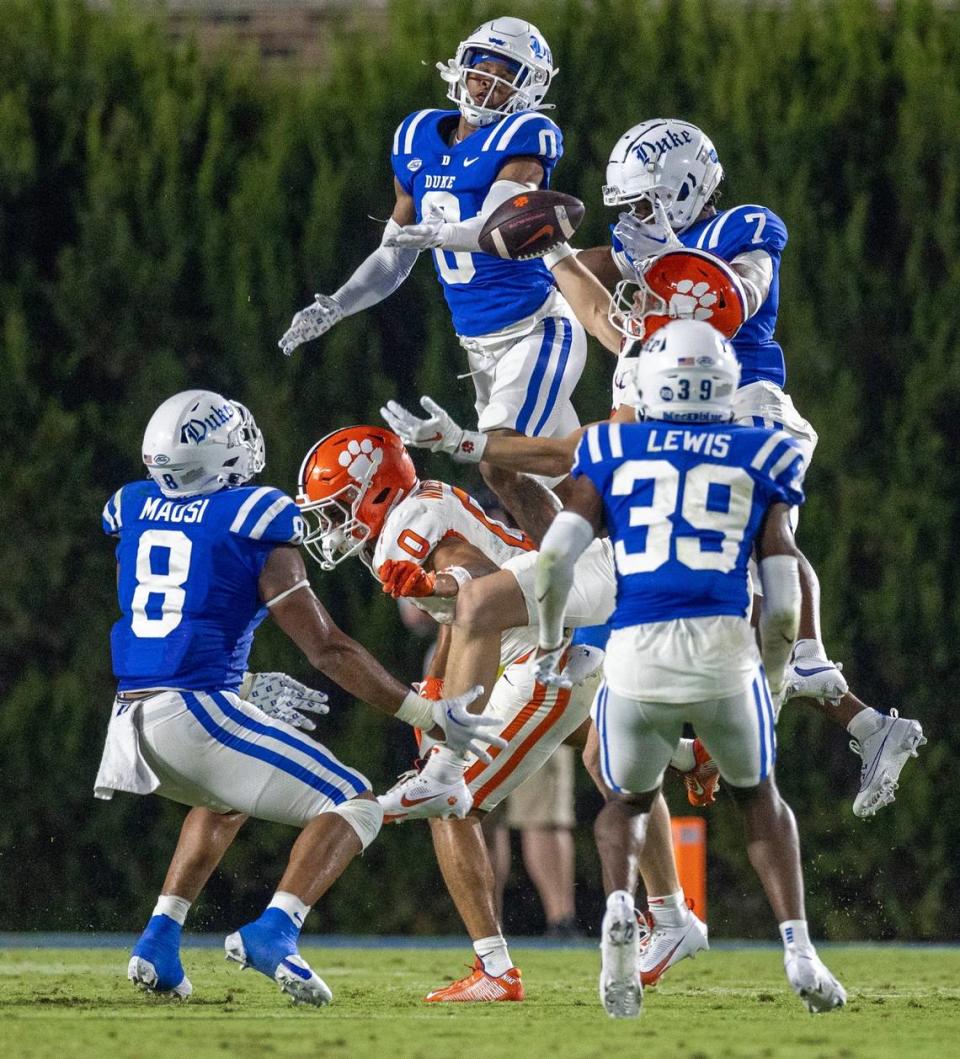 Duke’s Chandler Rivers (0) and Al Blades Jr. (7) try to intercept a pass by Clemson quarterback Cade Klubnik (2), that was deflected at the line of scrimmage in the first quarter on Monday, September 4, 2023 at Wallace Wade Stadium Stadium in Durham, N.C. Robert Willett/rwillett@newsobserver.com