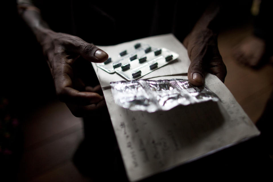 In this Sept. 1, 2012 photo, an HIV patient holds pills for his stomach ache and diarrhea at an HIV/AIDS center on the outskirts of Yangon, Myanmar. Following a half century of military rule, care for HIV/AIDS patients in Myanmar lags behind other countries. Half of the estimated 240,000 people living with the disease are going without treatment and 18,000 are dying from it every year. (AP Photo/Alexander F. Yuan)