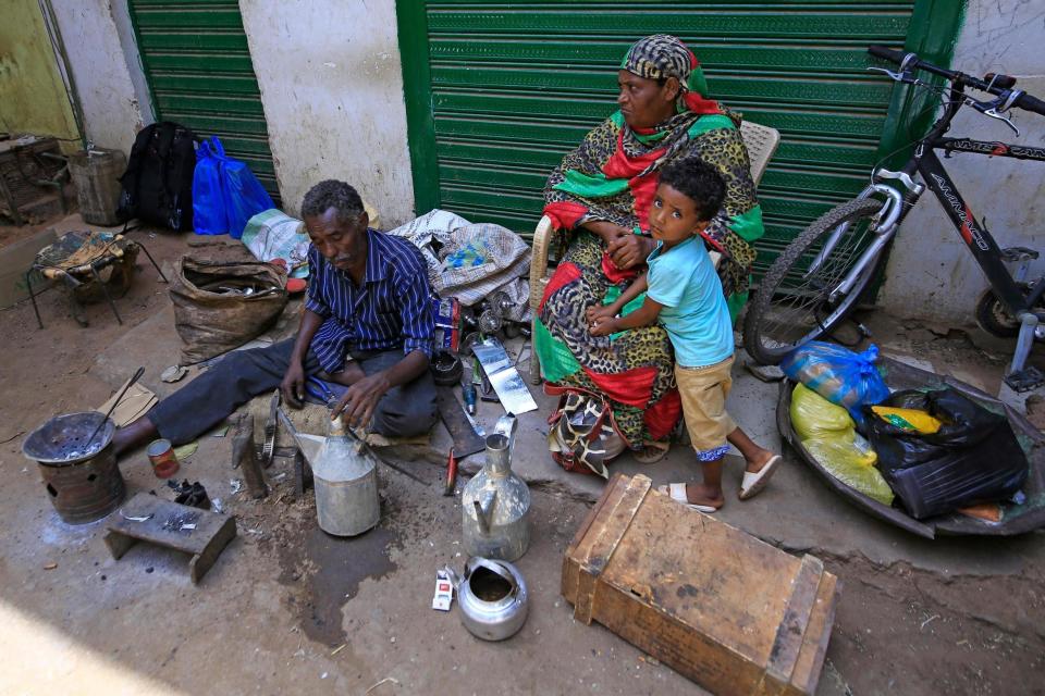 A blacksmith works at a street market in the Sudanese capital's twin city of Omdurman (AFP via Getty Images)