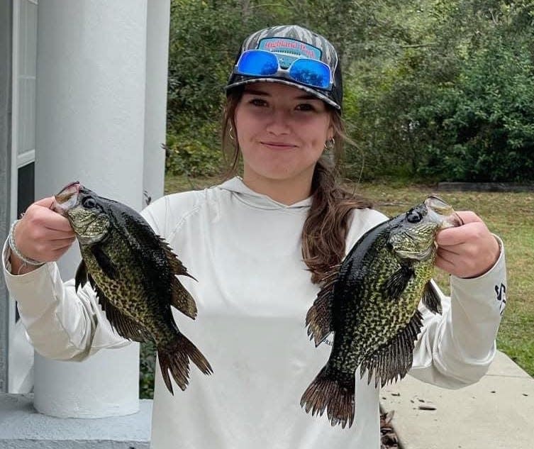 Rylyn Rogers, of DeLand, cruised out of Highland Park Fish Camp and returned later with this pair of speckled perch.
