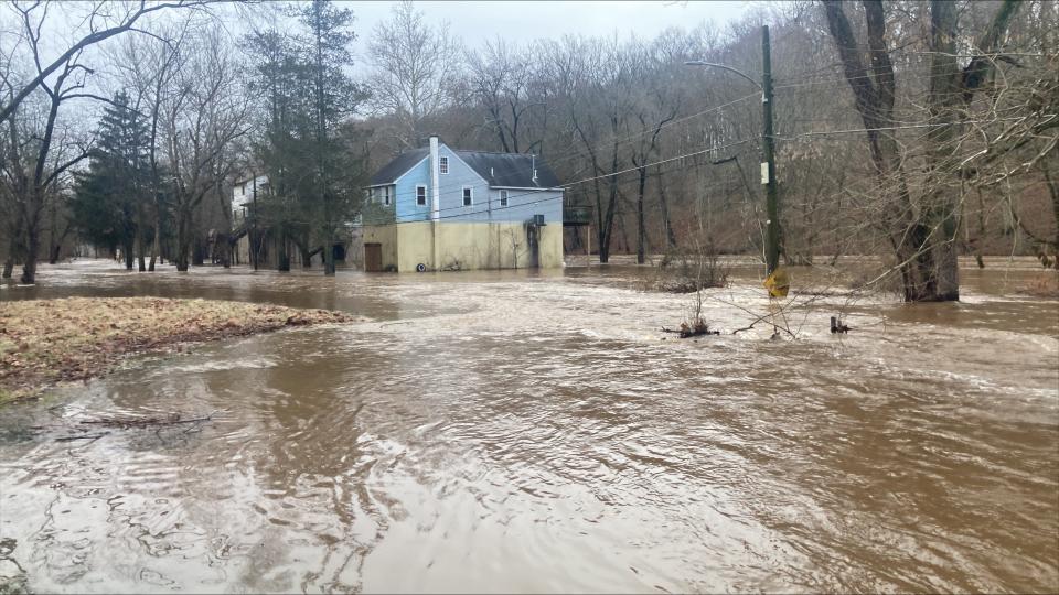 A house on Periwinkle Avenue in Middletown sits surrounded by water after the Neshaminy Creek spilled its banks due to a storm Tuesday.