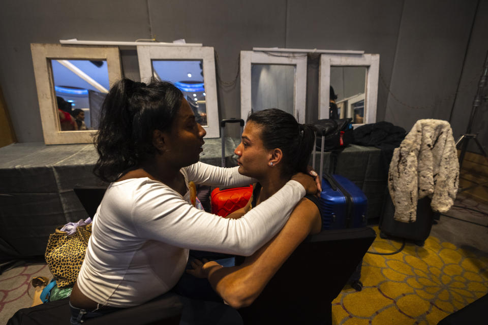 A friend talks a contestant back stage before the start of Miss Trans Northeast 22, beauty pageant in Guwahati, India, Wednesday, Nov. 30, 2022. In a celebration of gender diversity and creative expression, a beauty pageant in eastern Indian state of Assam brought dozens of transgender models on stage in Guwahati. Sexual minorities across India have gained a degree of acceptance especially in big cities and transgender people were given equal rights as a third gender in 2014. But prejudice against them persists and the community continues to face discrimination and rejection by their families. (AP Photo/Anupam Nath)