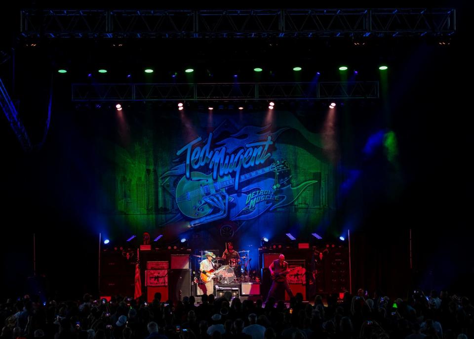 Ted Nugent, left, performs with Johnny Schoen on bass and Fraser native Jason Hartless on drums during the Adios Mofo '23 stop at Michigan Lottery Amphitheatre on Aug. 11, 2023, in Sterling Heights.