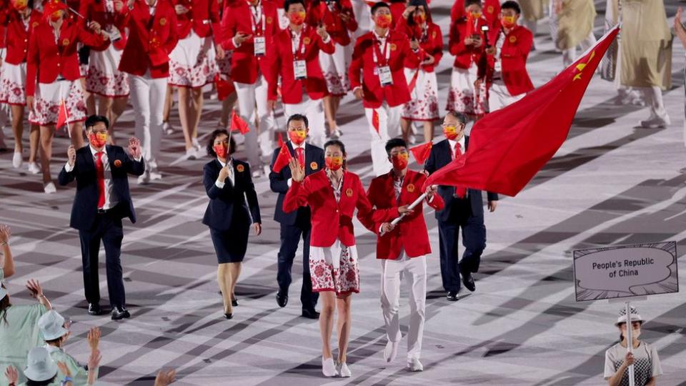 Flag bearers Ting Zhu and Shuai Zhao of Team China lead their team out during the Opening Ceremony of the Tokyo 2020 Olympic Games at Olympic Stadium on July 23, 2021 in Tokyo, Japan.