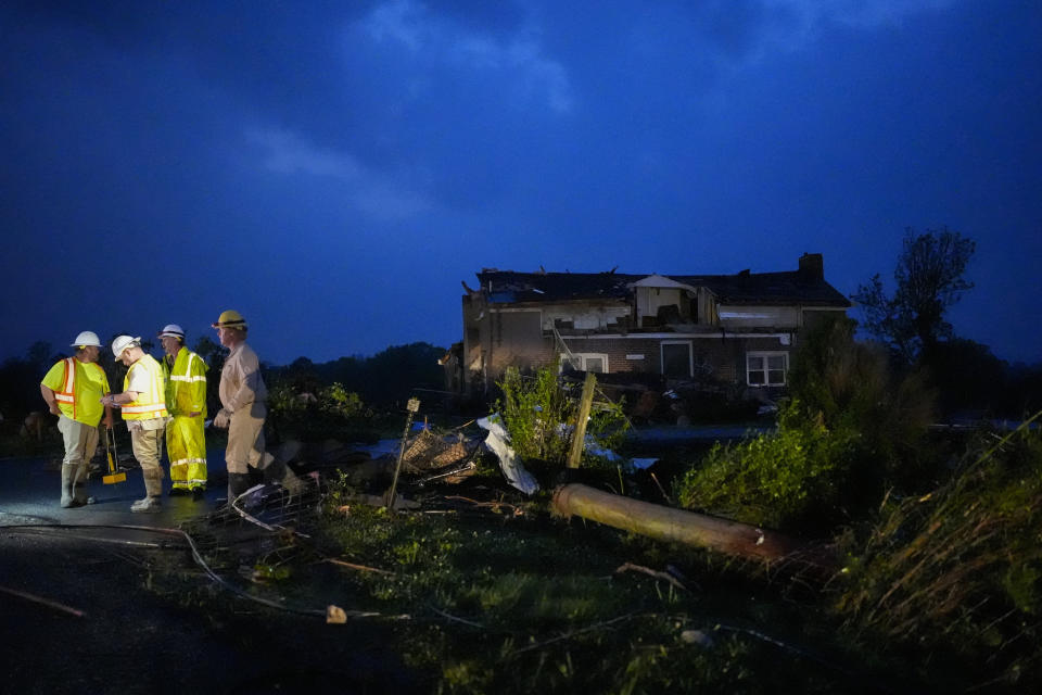 Utility workers survey storm damage along Cothran Road, Wednesday, May 8, 2024, in Columbia, Tenn. The weather comes on the heels of a stormy April in which the U.S. had 300 confirmed tornadoes, the second-most on record for the month and the most since 2011. (AP Photo/George Walker IV)