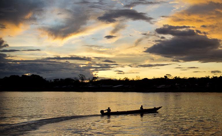 Fishermen sail on a boat on the river Atrato in Quibdo, Department of Choco, Colombia, on November 21, 2014