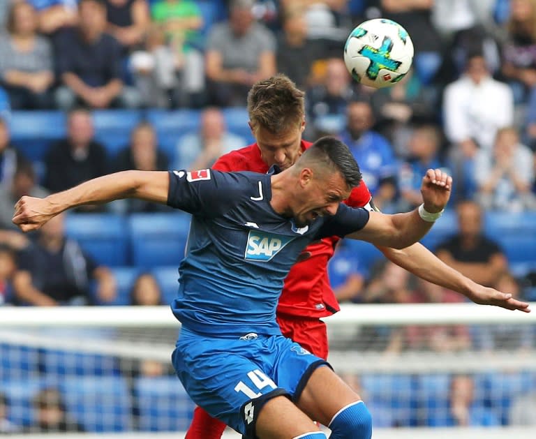 Hoffenheim's forward Sandro Wagner (front) and Berlin's defender Sebastian Langkamp fight for the ball during their Bundesliga match in Sinsheim, southwest Germany, on September 17, 2017