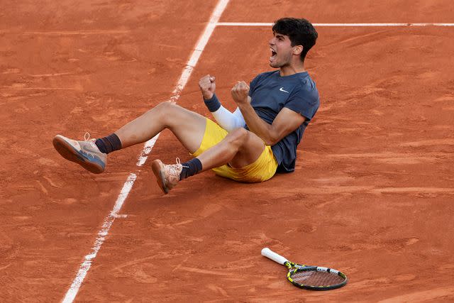 <p>Jean Catuffe/Getty</p> Carlos Alcaraz of Spain celebrates winning the men's final against Alexander Zverev of Germany on Day 15 of the 2024 French Open at Roland-Garros Stadium