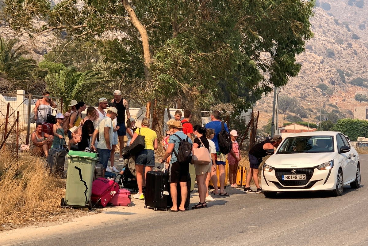 Tourists are being evacuated as wildfire burns near Lindos, on the island of Rhodes (REUTERS)