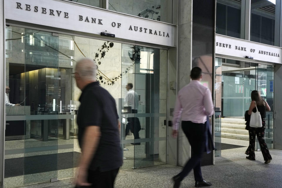 People arrive at the Reserve Bank of Australia in Sydney, Tuesday, Dec. 6, 2022. Australia's central bank has raised its benchmark interest rate by a quarter-point to 3.1% as it continues to battle inflation. (AP Photo/Rick Rycroft)