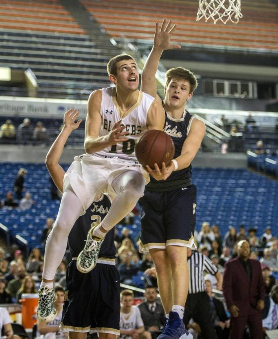 Timberline’s Erik Stevenson rises to the net past Kelso defenders during his final high school game at the Class 3A state tournament in the Tacoma Dome on Saturday, February 3, 2018.