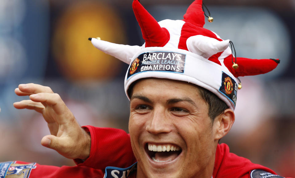 FILE - In this Saturday May 16, 2009 file photo, Manchester United's Cristiano Ronaldo smiles as the team celebrate winning the English Premier League after their 0-0 draw against Arsenal at Old Trafford Stadium, Manchester, England. Ronaldo, who joined Juventus for this season from Real Madrid, became the first player to win the English Premier League (with Manchester United), the Spanish league (with Madrid) and Serie A. (AP Photo/Jon Super, File)