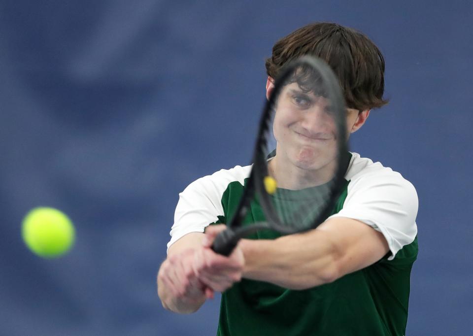 Firestone senior Reece Caraboolad returns the serve of North’s Sanjil Magar during the City Series tournament at Towpath Tennis Center, Wednesday, May 3, 2023.