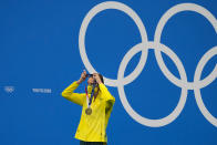 Emma Mckeon, of Australia, puts on her gold medal during a victory ceremony for the women's 50-meter freestyle final at the 2020 Summer Olympics, Sunday, Aug. 1, 2021, in Tokyo, Japan. (AP Photo/Jae C. Hong)