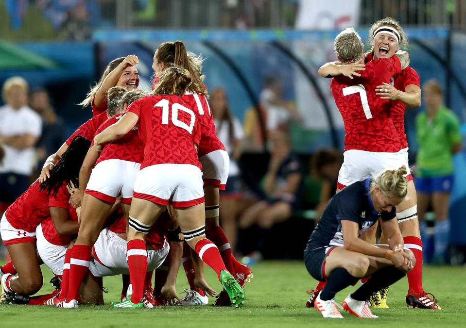 <p>Team Canada celebrates their victory winning the Bronze medal after the Women’s Bronze Medal Rugby Sevens match between Canada and Great Britain on Day 3 of the Rio 2016 Olympic Games at the Deodoro Stadium on August 8, 2016 in Rio de Janeiro, Brazil. (Photo by David Rogers/Getty Images) </p>