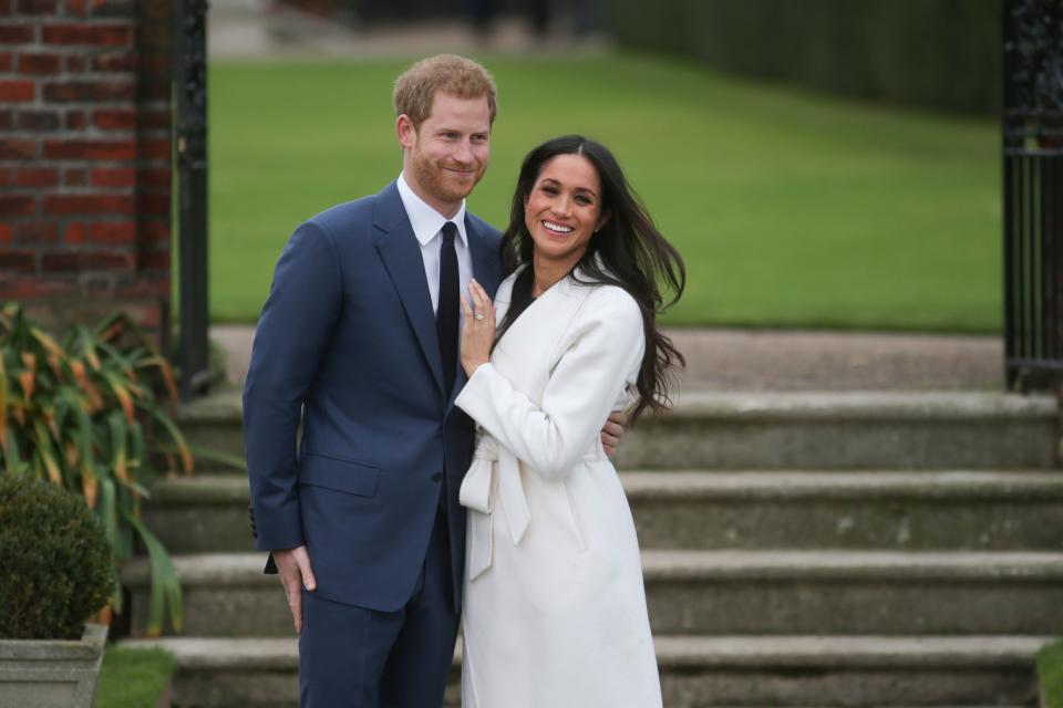 Britain's Prince Harry and his fiancée US actress Meghan Markle pose for a photograph in the Sunken Garden at Kensington Palace in west London on November 27, 2017, following the announcement of their engagement