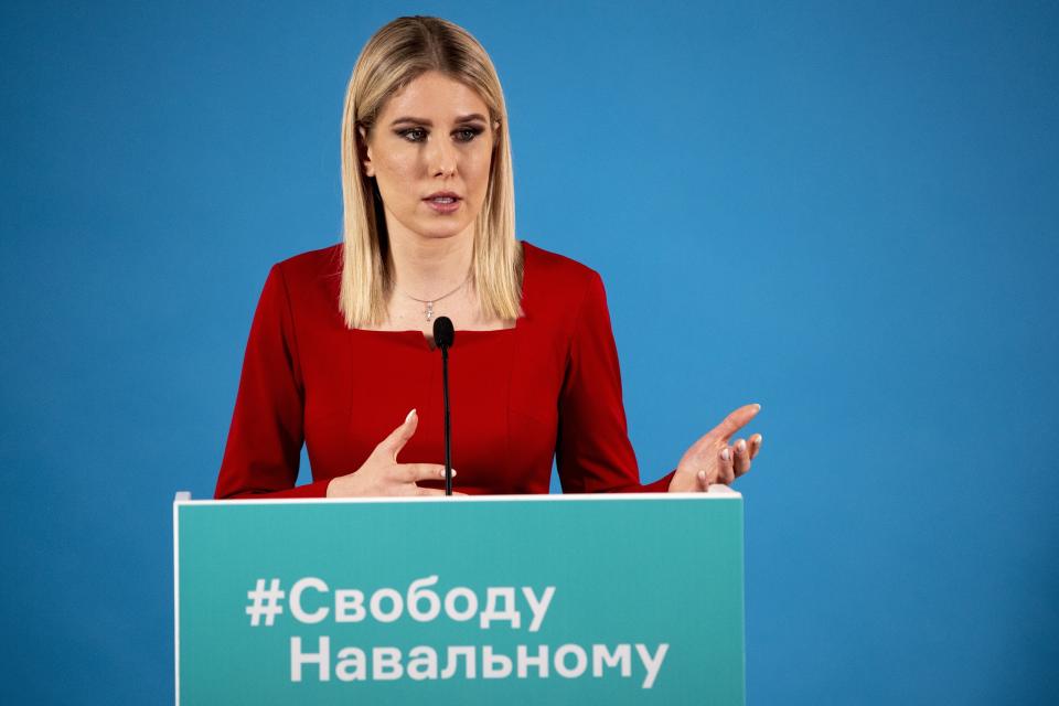 FILE - In this file photo taken on Tuesday, Jan. 26, 2021, Lyubov Sobol, an ally of jailed Russian opposition leader Alexei Navalny, speaks during a videoconference in Moscow, Russia. The words on her lectern read "Free Navalny." Rattled by the nationwide demonstrations supporting him, Russian authorities are moving rapidly to block any new ones – from piling legal pressure on his allies to discrediting the rallies. On Wednesday, Moscow police raided apartments and offices belonging to Navalny associates and opposition figures, including his own apartment and Sobol's. (AP Photo/Pavel Golovkin, File)