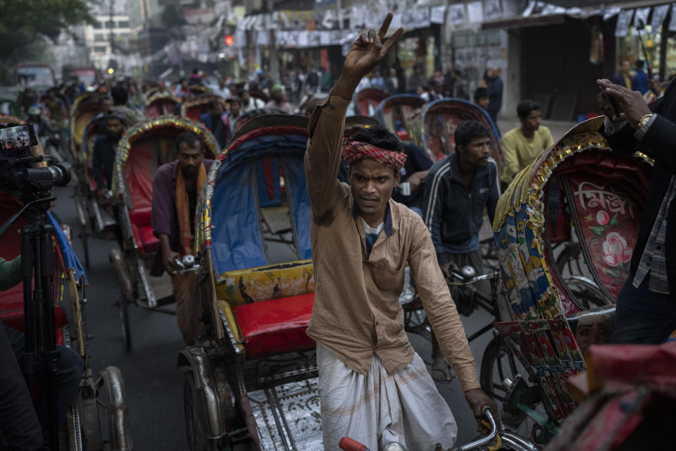 A rickshaw puller shouts slogans as supporters and activists of Gono Odhikar Porishod party march demanding free and fair elections and supporting the boycott of Sunday's parliamentary elections, in Dhaka, Bangladesh, Friday, Jan. 5, 2024. Bangladesh's main opposition party called for general strikes on the weekend of the country's parliamentary election, urging voters to join its boycott. This year, ballot stations are opening amid an increasingly polarized political culture led by two powerful women; current Prime Minister Sheikh Hasina and opposition leader and former premier Khaleda Zia. (AP Photo/Altaf Qadri)