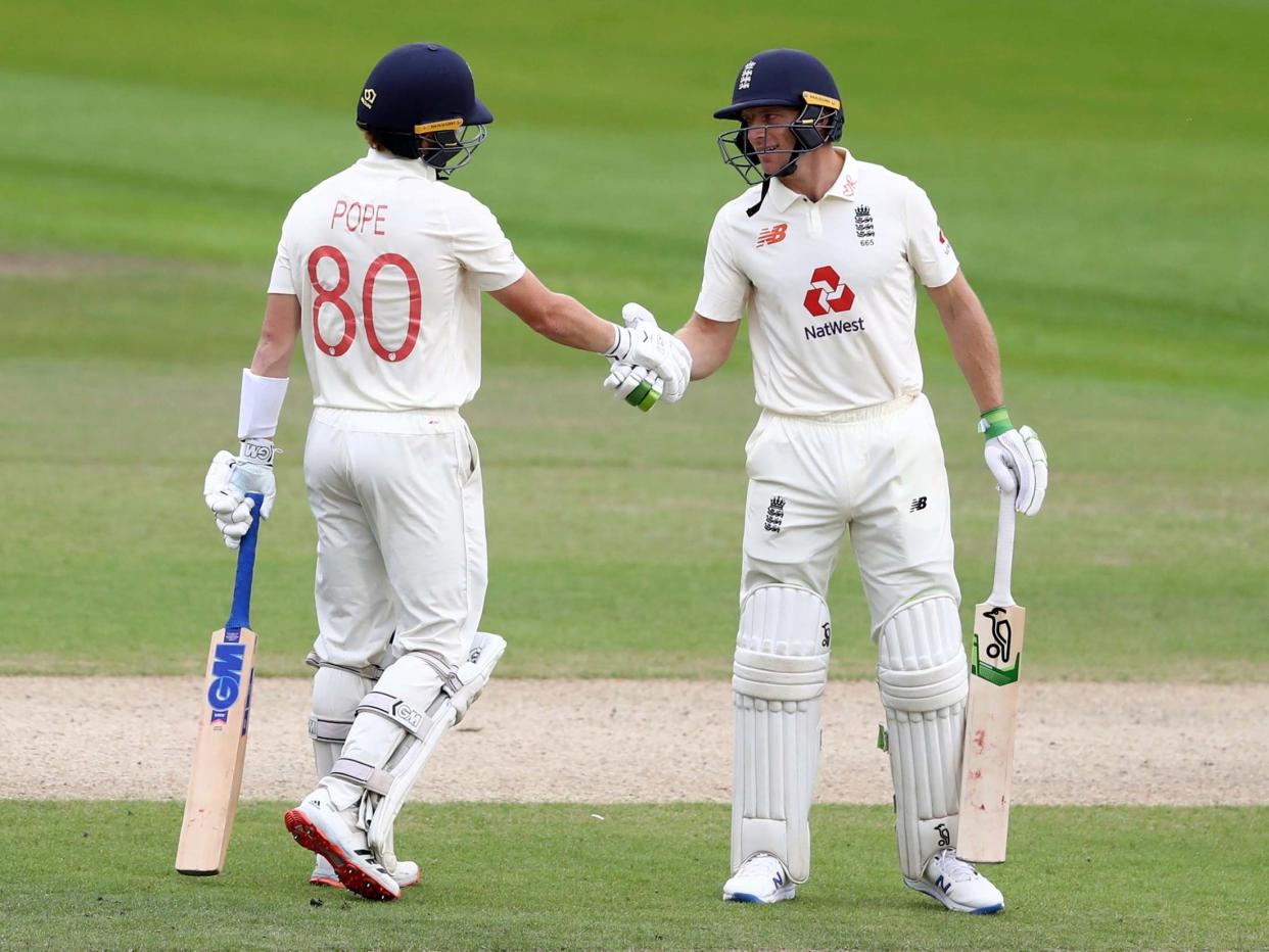 Jos Buttler congratulates Ollie Pope on his half-century: AP