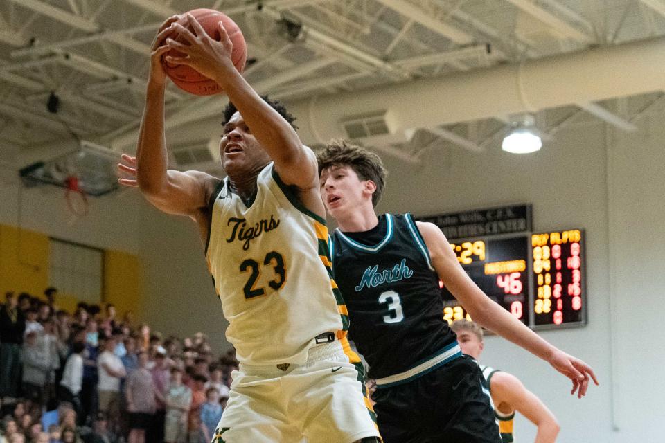 St. Xavier's Jeremiah Jackson (23) grabs the rebound against North Oldham's David Bradley (3) during the game on Friday, February 23, 2024, at St. Xavier's.