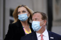 Mark and Patricia McCloskey leave following a court hearing Wednesday, Oct. 14, 2020, in St. Louis. The McCloskeys have pleaded not guilty to two felony charges, unlawful use of a weapon and tampering with evidence, after been seen waving guns at protesters marching on their private street this past summer. (AP Photo/Jeff Roberson)