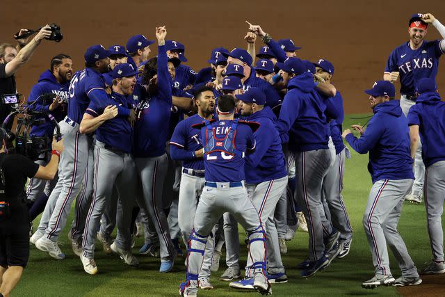 <p>Jamie Squire/Getty</p> The Texas Rangers celebrate their first World Series victory