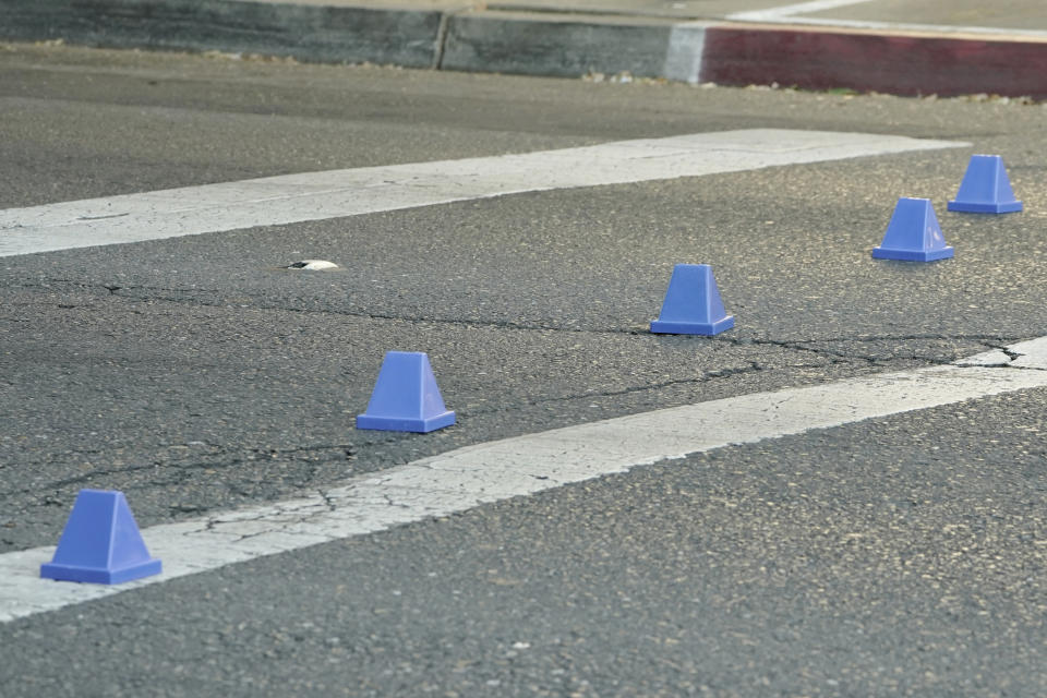 Evidence markers are on a street near the scene of a fatal shooting that also injured others outside of a downtown Sacramento, Calif., night club in the early morning hours on Monday, July 4, 2022. (AP Photo/Rich Pedroncelli)