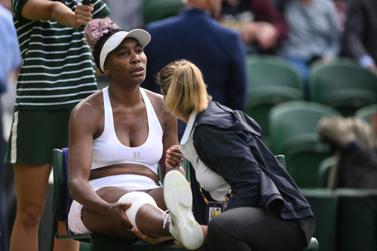 Venus Williams receives medical attention during her match against Ukraine&#39;s Elina Svitolina on Monday in the first round of Wimbledon. (Photo by DANIEL LEAL/AFP via Getty Images)