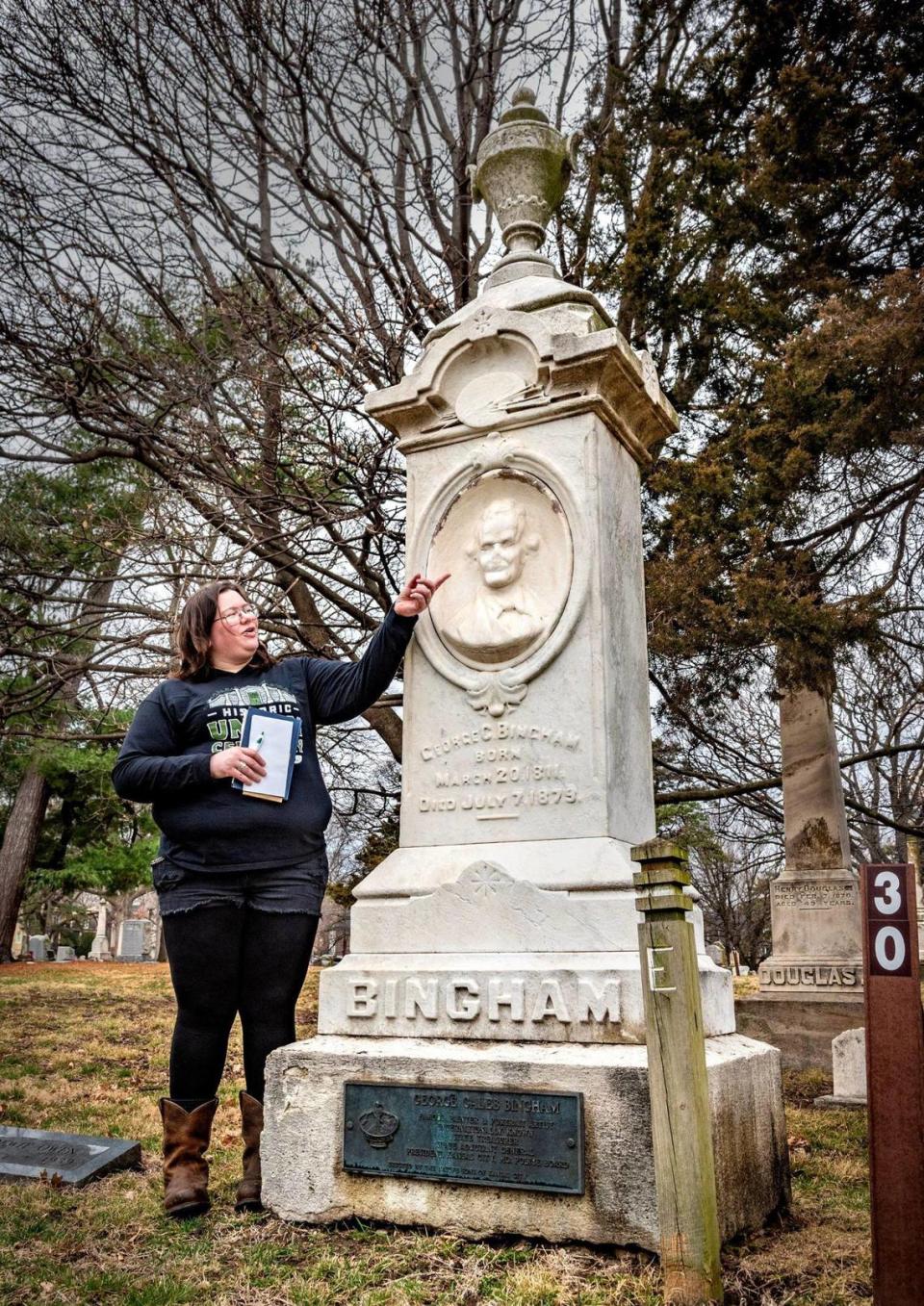 Heather Faries, vice president of the Union Cemetery Historical Society, stands at the grave of famed Midwest artist George Caleb Bingham.