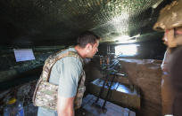 FILE In this file photo taken on Thursday, Aug. 6, 2020, Ukrainian President Volodymyr Zelenskiy looks through an embrasure as he visits the war-hit Donetsk region, eastern Ukraine. Ukrainians are heading to the polls on Sunday, Oct. 25, 2020 to cast ballots in local elections seen as a key test for President Volodymyr Zelenskiy. Zelenskiy, a popular comedian without prior political experience, was elected by a landslide in April 2019 on promises to end fighting with Russia-backed separatists in eastern Ukraine, uproot endemic corruption and shore up a worsening economy. (Ukrainian Presidential Press Office via AP, File)