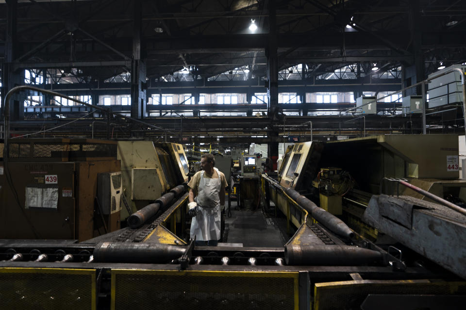 A steel worker operates a machine used in the manufacturing of 155 mm M795 artillery projectiles at the Scranton Army Ammunition Plant in Scranton, Pa., Thursday, April 13, 2023. One of the most important munitions of the Ukraine war comes from a historic factory in this city built by coal barons, where tons of steel rods are brought in by train to be forged into the artillery shells Kyiv can’t get enough of — and that the U.S. can’t produce fast enough. (AP Photo/Matt Rourke)