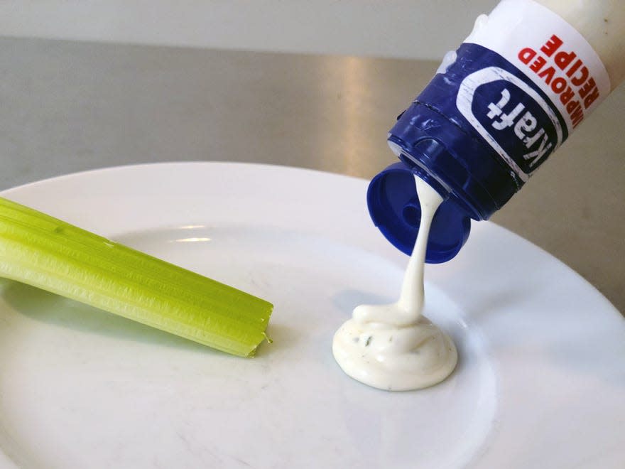 Kraft ranch dressing being poured onto a plate.