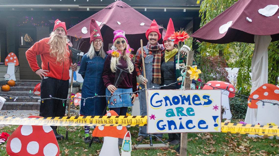 Greg Durand, left, stands with others dressed as gnomes at their gnome workshop themed Halloween yard on Harrison Boulevard in Boise on Oct 31, 2022.