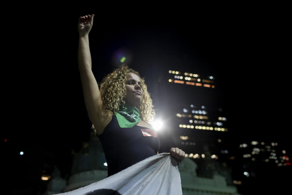 A woman raises her fist during a protest against an anti-abortion bill in Brazil's Congress, in Rio de Janeiro, Thursday, June 13, 2024. (AP Photo/Bruna Prado)