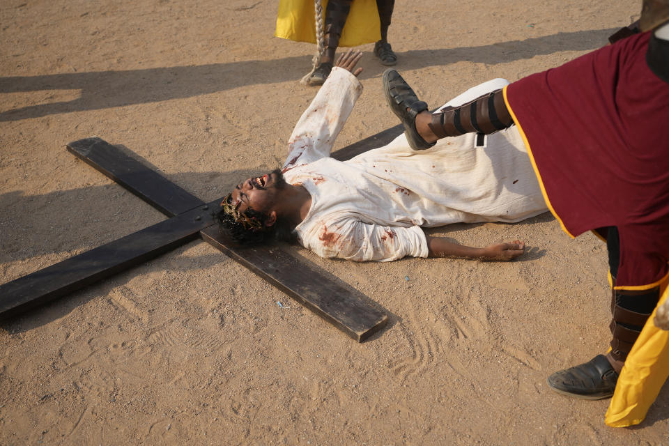 Christians reenact the crucifixion of Jesus Christ to mark Good Friday at Holy Family Church in Hyderabad, India, Friday, March 29, 2024. Christians all over the world attend mock crucifixions and passion plays that mark the day Jesus was crucified, known to Christians as Good Friday. (AP Photo/Mahesh Kumar A.)