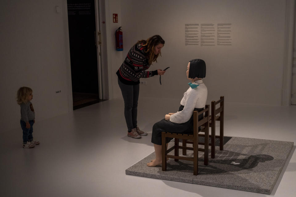A visitor takes photos to the statue of A Girl of Peace, by Kim Eun-Sung & Kim Seo-Kyung at Barcelona's Museum of Forbidden Art in Barcelona, Spain, Wednesday, Nov. 8, 2023. Exhibited as part of the Aichi Triennale 2019 in Japan, the artwork received threats of attack for being anti-Japanese propaganda. The Exhibition was closed but reaction against its censorship forced it to be reopened. This artwork has caused various diplomatic incidents between Japan and South Korea. For its creators, it is a icon of peace. A new museum in Barcelona is offering a second chance to controversial artworks that have suffered censorship for religious, sexual, political or commercial reasons. (AP Photo/Emilio Morenatti)