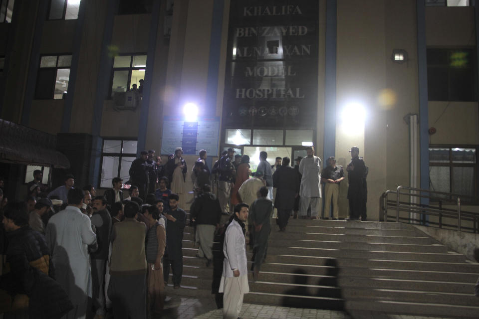 Police officers and people gather at a hospital where earthquake victims are brought, in Saidu Sharif, a town Pakistan's Swat valley, Tuesday, March 21, 2023. A magnitude 6.5 earthquake rattled much of Pakistan and Afghanistan on Tuesday, sending panicked residents fleeing from homes and offices and frightening people even in remote villages. (AP Photo/Naveed Ali)