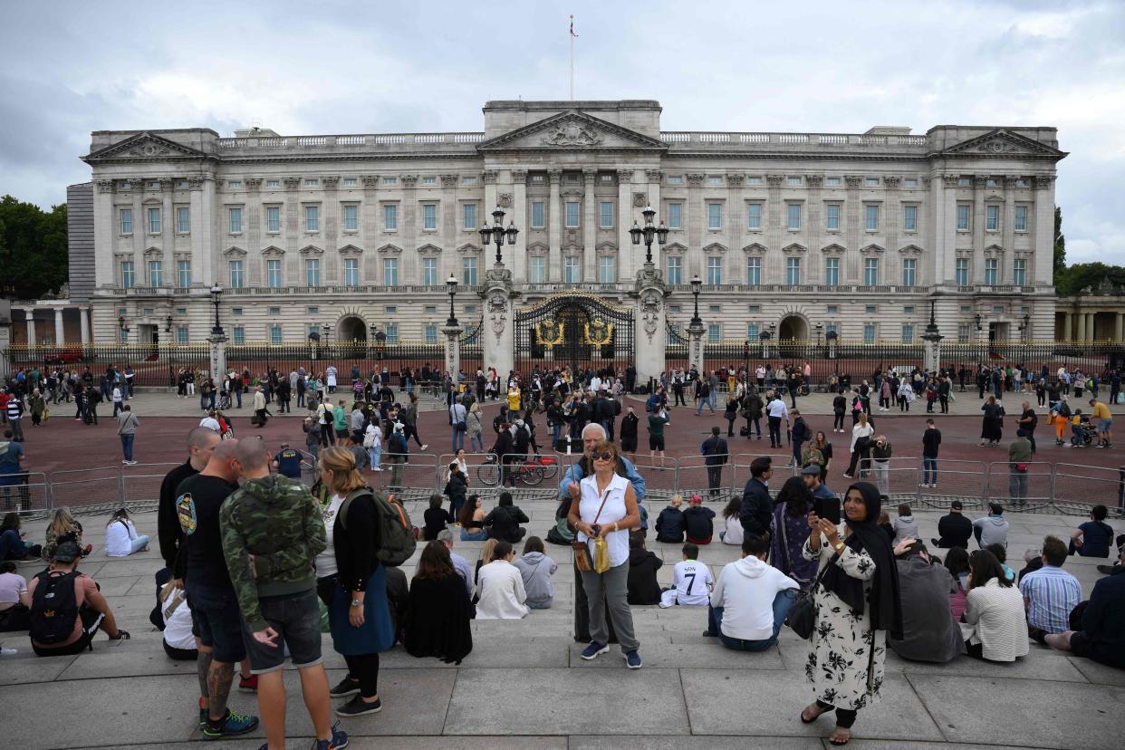 Crowds gather outside Buckingham Palace in London on Thursday.